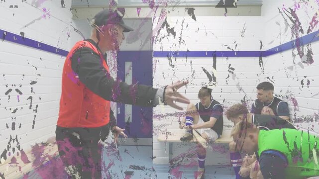 Vertical video: Male coach red bib giving half locker room talk urging team tying boots, copy space