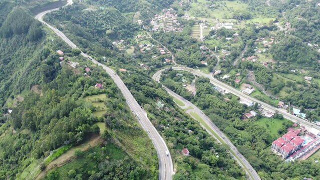 Road in middle of mountains cars and ciclist La vega Cundinamarca Colombia, cloudy sky