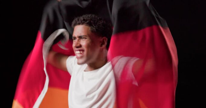 African American man entering dark studio draping tricolor flag unfurling lifting waving rallying