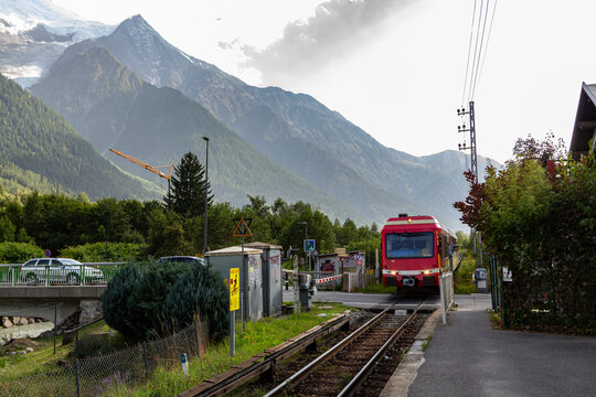 Chamonix-Mont-Blanc, Haute Savoie, France - August 09th, 2025: Level crossing of an SNCF train in Les Pelerins, with the train's electrical power supplied by direct current via a dangerous third rail.