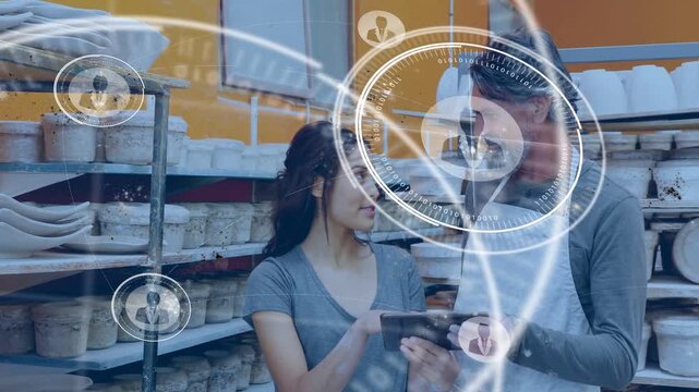 Two staff holding tablet while woman tapping in pottery shop HUD rings growing and guiding workflow