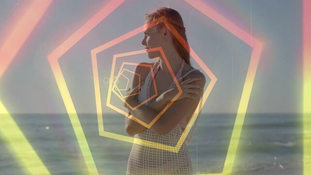 Camera rolling, rotating pentagons aligning over woman posing on beach, showing coverup for fashion