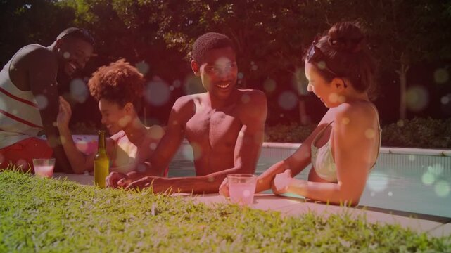 Friends leaning poolside man leaning forward causing lifestyle chat, warm bokeh overlaying group