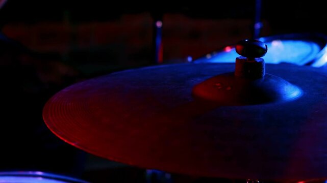 Yellow bolts appearing over cymbal as red or blue lights shifting, pulsing, accenting drums