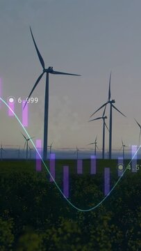Group of wind turbines standing over flowering field at dawn showing purple bars and cyan waveform