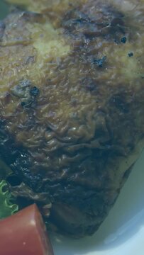 Roasted poultry filling frame, camera panning, spawning grid bars rising for food marketing