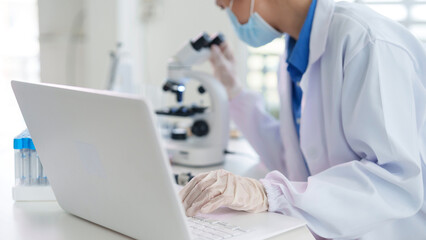 Asian adult scientist researcher medical professional performs scientific research experiment...