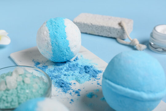 Bath bombs, sea salt and pumice stone on color background, closeup