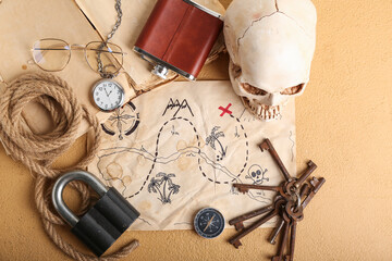 Treasure map with travel equipment, human scull and hip flask on beige background © Pixel-Shot