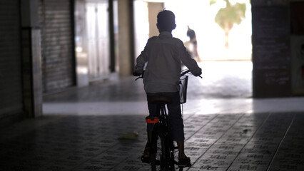 funny boy rides a bicycle down the street, have fun and enjoy © vla