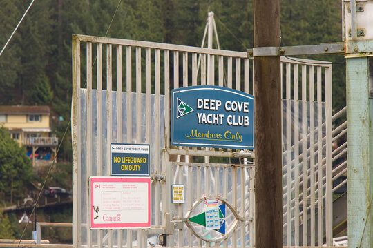 Deep Cove Yacht Club Members Only sign on wooden gate with No Tr