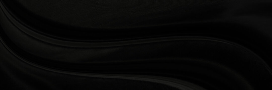 Black gray satin dark fabric texture luxurious shiny that is abstract silk cloth panorama background with patterns soft waves blur beautiful.