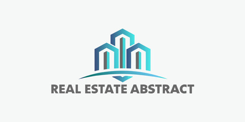 Fototapeta premium Abstract building logo with blue and teal gradients reading real estate