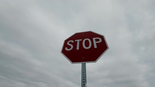 Stop sign in urban environment signaling drivers to halt at intersection. Traffic safety symbol on roadside
