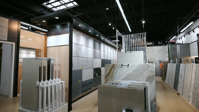Element of Modern tile showroom interior with large ceramic and porcelain slabs displayed in vertical racks. Wide view