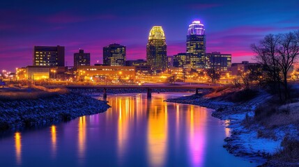 Fototapeta premium vibrant twilight city skyline with illuminated skyscrapers reflecting on calm river, snow-lined banks and bridge, serene colorful evening atmosphere