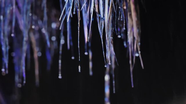 Close view of rain falling from thatched roof in Coron Philippines, night scene