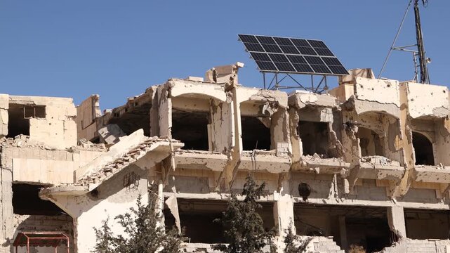 External view of the ruined Ma'aloula Hotel in Syria, showing structural damage from the civil war. Significant landmark destroyed during the conflict