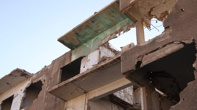 Close-up of a destroyed concrete building in the Jobar neighborhood of Damascus, Syria. Evidence of heavy shelling and combat from the Syrian Civil War