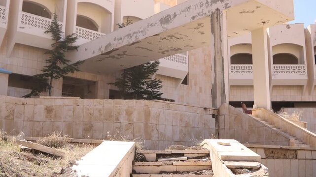 Close-up of ruined concrete stairs at the Ma'aloula Hotel, Syria. Debris and destruction caused by the Syrian Civil War
