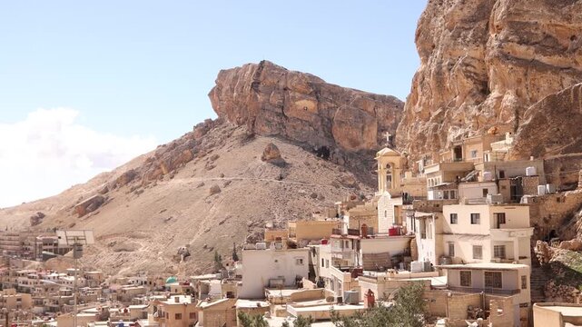 Wide view of the Monastery built into the sheer rocky cliffs of Ma'aloula, Syria. Famous Christian pilgrimage site known for its ancient history and unique mountain architecture