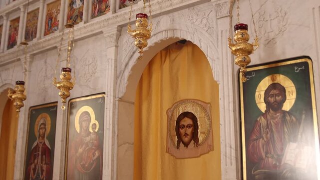 Detailed interior shot of Christian religious icons and golden art inside the historic Saint Thecla Monastery in Ma'aloula