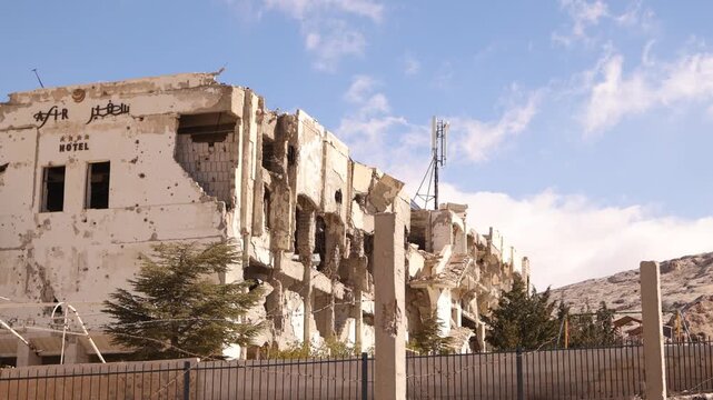 Detailed view of the crumbling walls and debris of the Ma'aloula Hotel ruins in Ma'aloula, Syria. A stark reminder of the destruction caused by the Syrian Civil War conflict