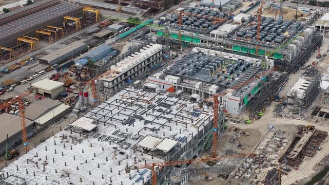 Aerial drone video of Data Centre QHI01 hyperscale campus construction in Chonburi, Thailand, within the Eastern Economic Corridor, showing large scale cloud computing, AI infrastructure, and
