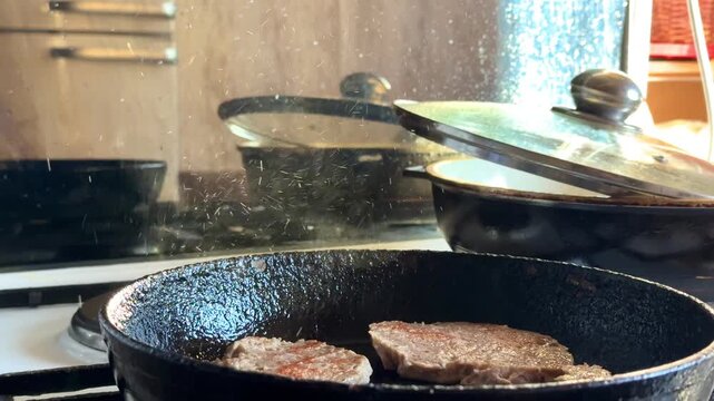 Close-up boiling oil background with meat are fried in a frying pan in boiling oil, olive oil texture. High quality 4k
