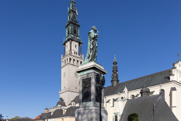 Monument to Father Augustyn Kordecki and tower of baroque Jasna Gora Basilica, Czestochowa, Poland © mychadre77