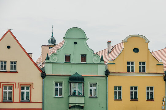 Eastern Europe 19th century houses, crumbling facade, cracked plaster and paint, neglected old town center.