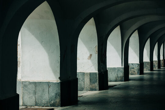 Nineteenth-century arcade under houses for pedestrian passage, shadow, old town, Europe