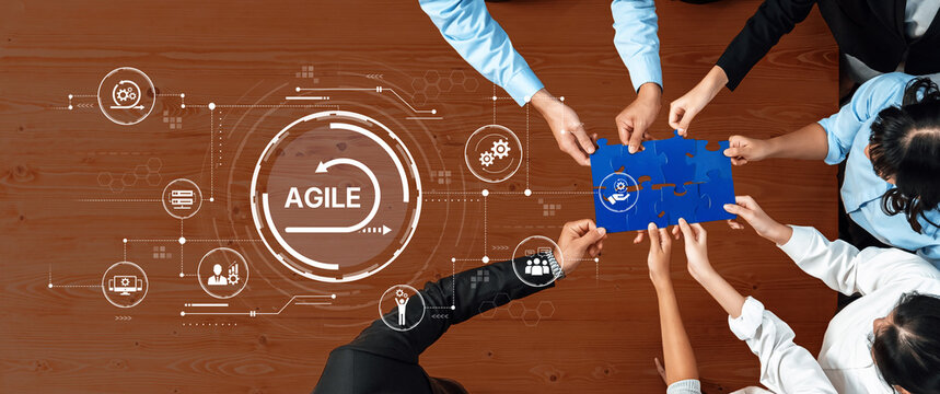 A diverse team collaborates on an agile project by holding a puzzle piece, surrounded by digital icons, representing innovation and teamwork in an office space. Trope