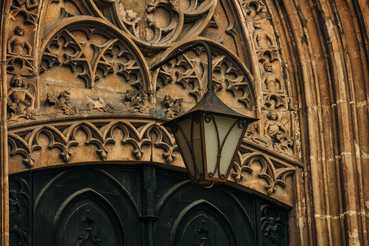Massive old lantern above arched church entrance portal, 18th century, Europe