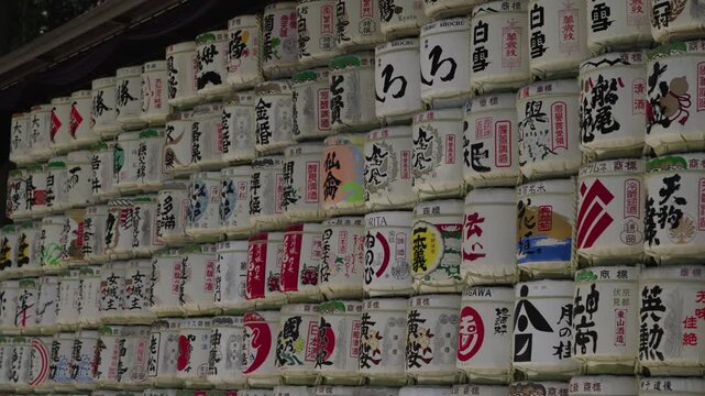 Stacked decorative sake barrels at a traditional Japanese shrine in Tokyo representing cultural offerings and heritage