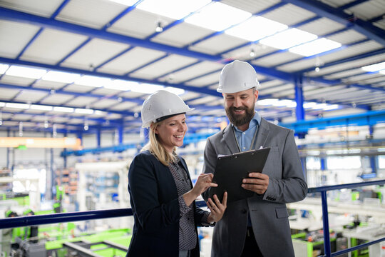 Industrial team analyzing data in high tech manufacturing plant.