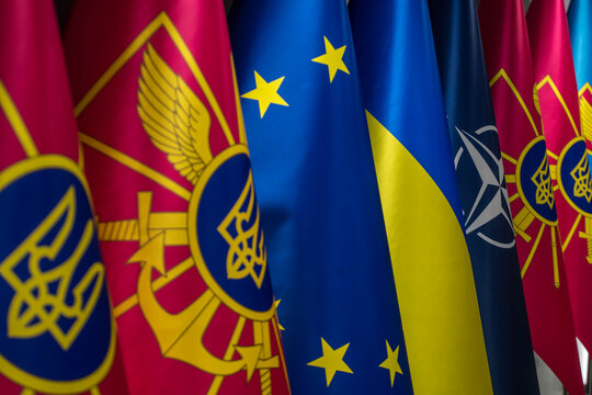The national flag of Ukraine, the European Union flag, and the flags of branches of the Armed Forces of Ukraine stand closely side by side in Kyiv