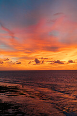 Obraz premium Aerial view of Balangan Beach curved shoreline with reef at sunset