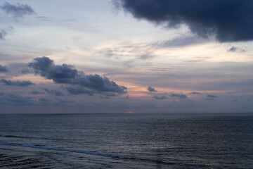 Fototapeta premium Overcast sky with dramatic clouds over calm ocean at Balangan Beach