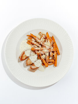 fried meat with sweet potatoes on a plate