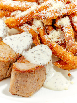 fried meat with sweet potatoes on a plate