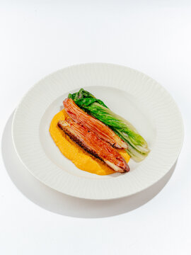 grilled duck breast with sauce and side dish