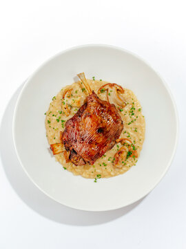 duck leg with side dish on a plate