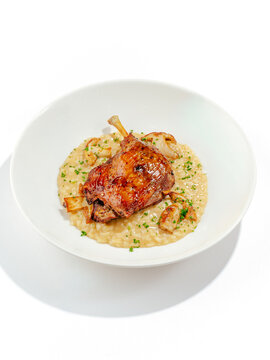 duck leg with side dish on a plate