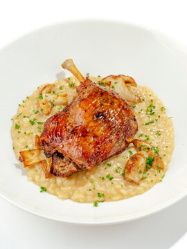 duck leg with side dish on a plate