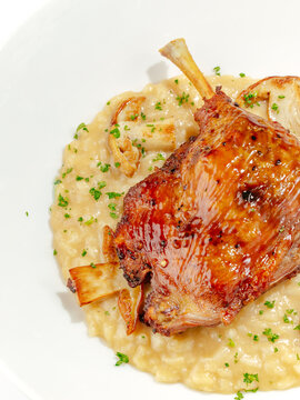 duck leg with side dish on a plate
