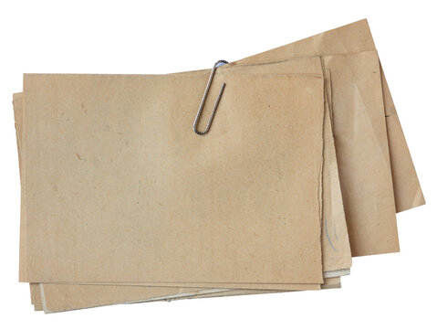 Stack of vintage brown paper sheets fastened with metal paper clip isolated on white