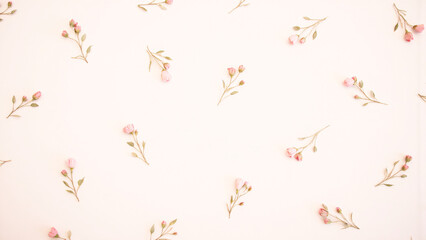 Fototapeta premium A delicate floral pattern unfolds with pink flowers and green leaves on a soft surface.