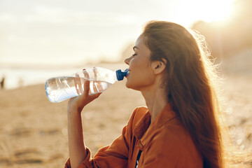 Woman drinking water outdoors, desert sunlight, hydration moment, side profile portrait, relaxed posture, summer wind, soft lens blur, warm natural colors, cheerful smile, steady hands © SHOTPRIME STUDIO