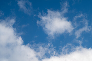 Fototapeta premium Peaceful sky with light clouds and gentle glow. Serene sky scene with scattered whitish clouds and soothing sunlight creating peaceful ambiance suitable for various designs